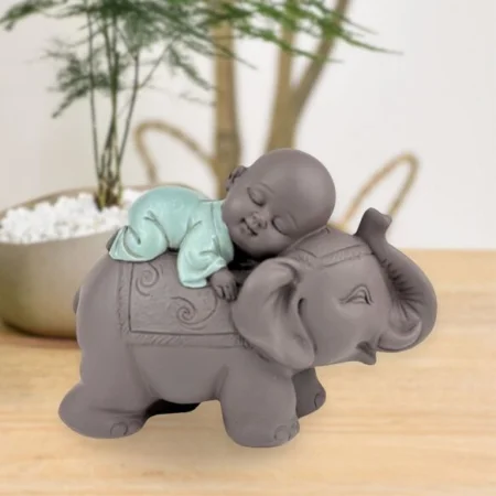 Estatuilla Monje buda bebe durmiendo en elefante